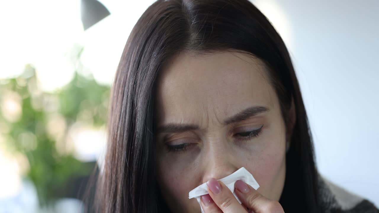 Woman with Cold Symptoms Using a Tissue