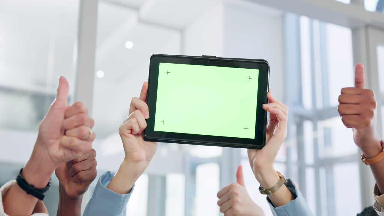 People giving thumbs up to a tablet with a green screen