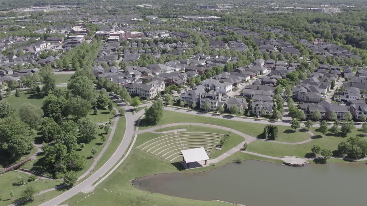 Aerial view of the Norton Commons neighborhood in Louisville, Kentucky, featuring homes and a small pond. Great for real estate, urban design, and regional footage.