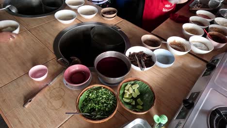 hands preparing food with multiple bowls and ingredients