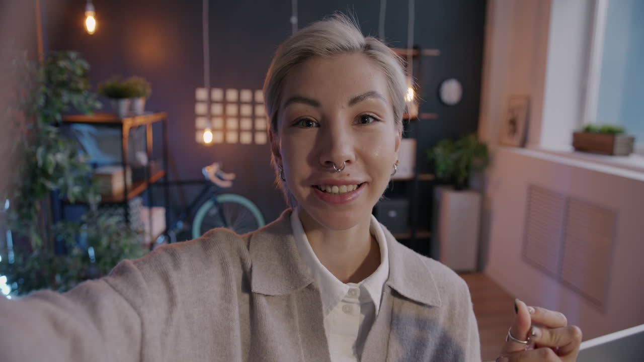 Woman taking selfie in home office