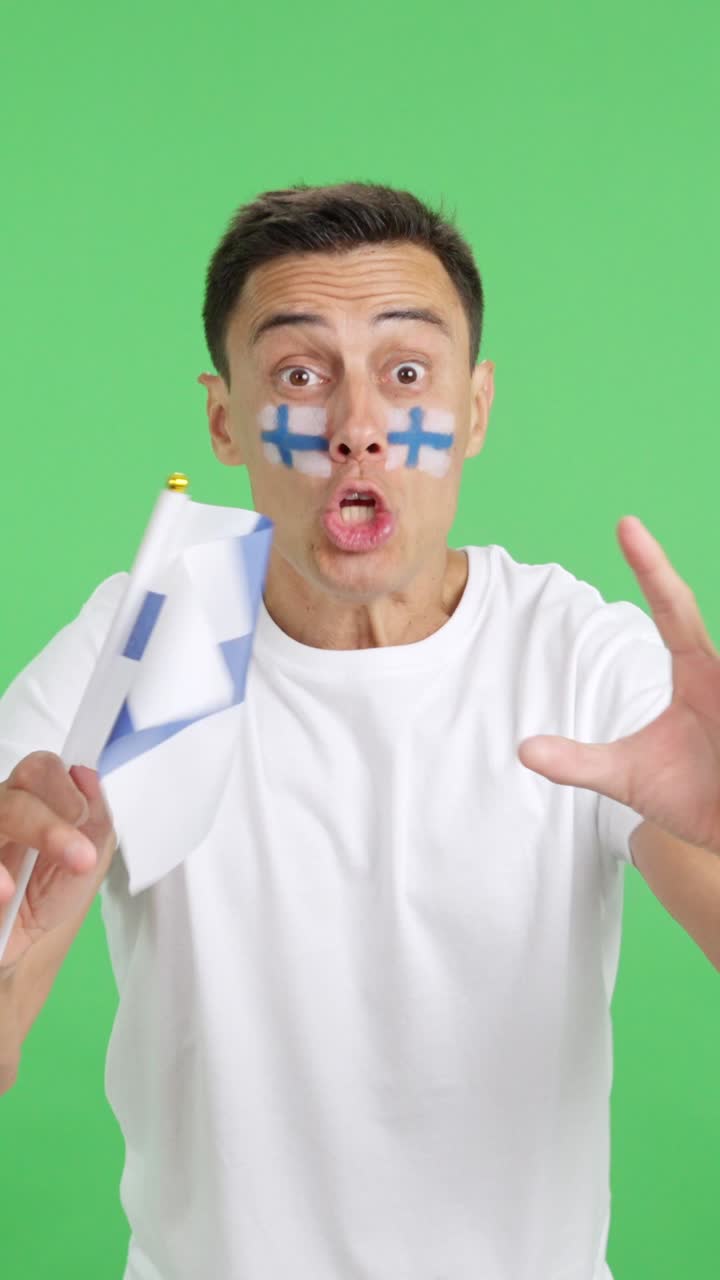 Man cheering for Finland screaming and waving a national flag