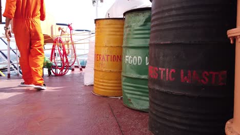 oil drums on a government ferry in the andaman islands are painted with words to describe the waste they should hold