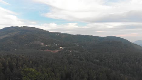 Aerial-wide-shot-of-a-green-forest-on-top-of-a-hill-in-Yercaud-on-a-summer-day,-conservation-concept