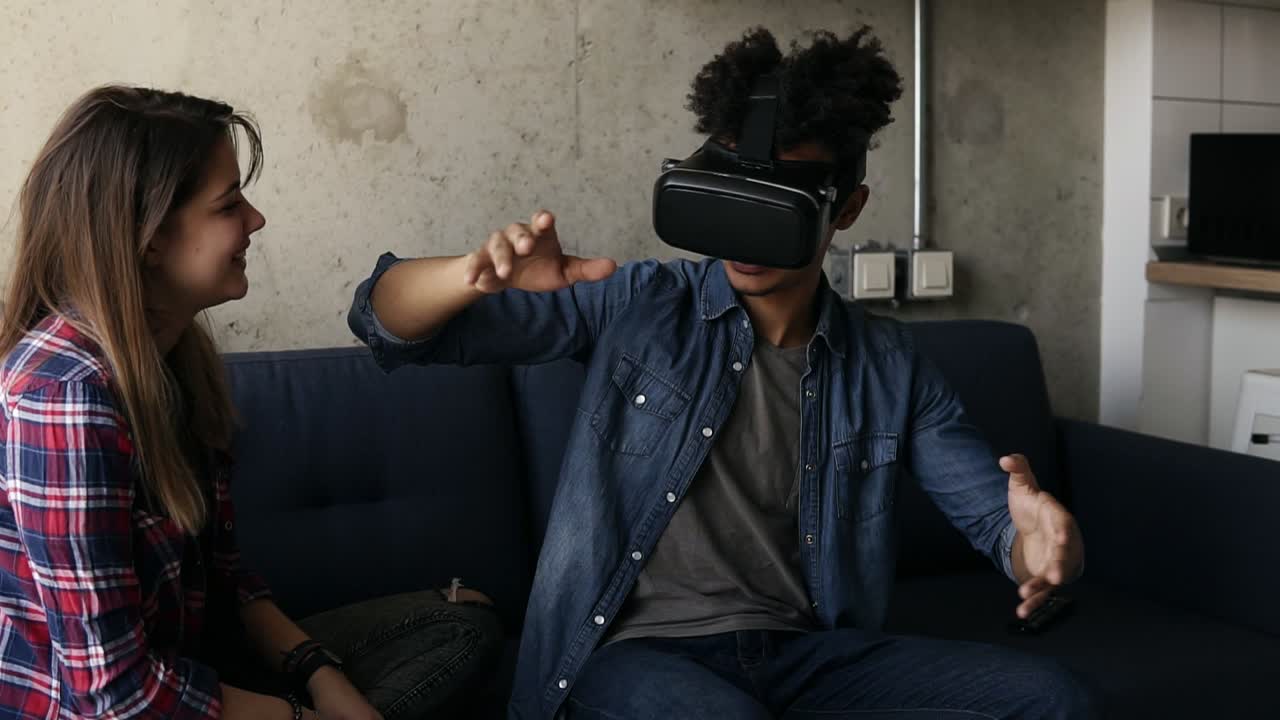 un joven experimentando un juego de realidad virtual con su novia ayudándolo.