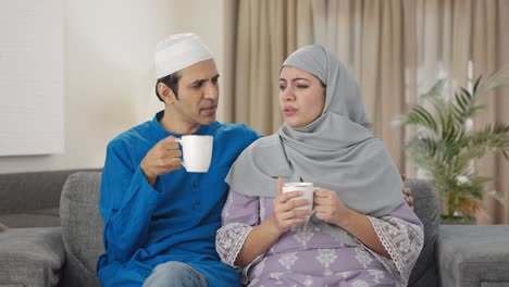 muslim couple drinking tea at home