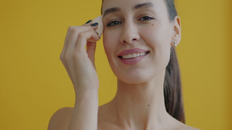woman applying makeup with a sponge