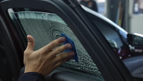 hand cleaning car window at carwash. closeup shot