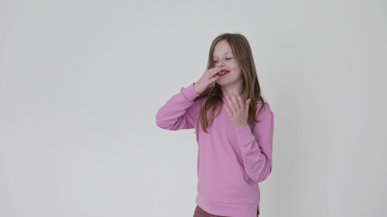 A girl in a pink sweater