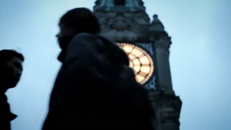 a captivating view of a majestic tower clock against a dusk sky, highlighting the intricate details and illuminated faces of the timepiece.