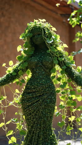 green ivy topiary sculpture of a female figure