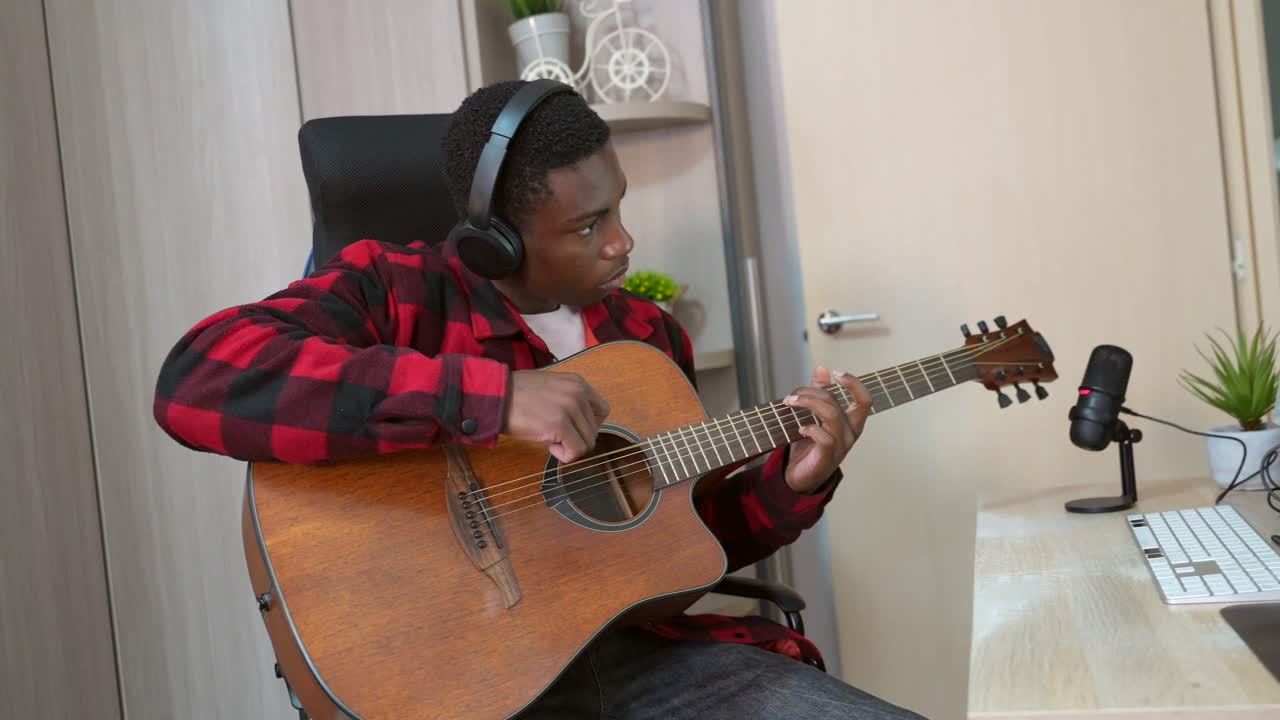 Man playing guitar in home studio