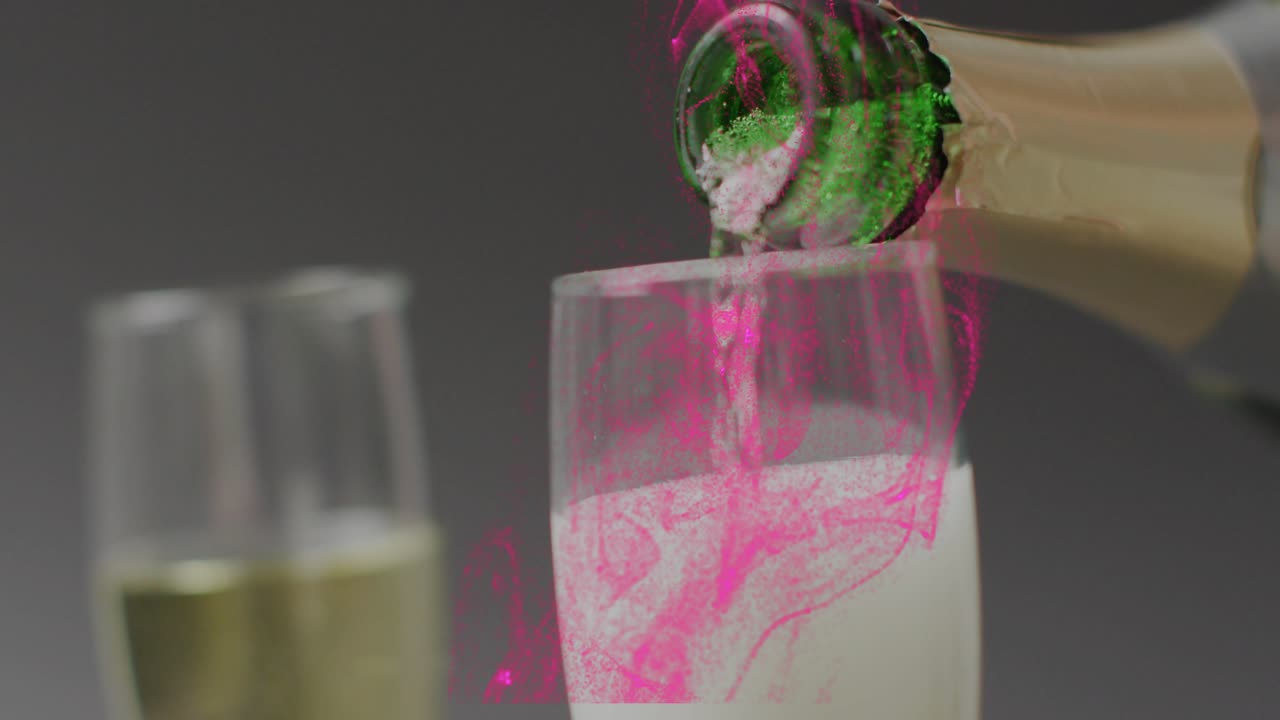 Pink droplet falling from top starting bottle pouring, tall flute filling and making frothy swirls
