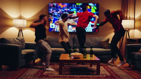friends celebrating a football game victory at home