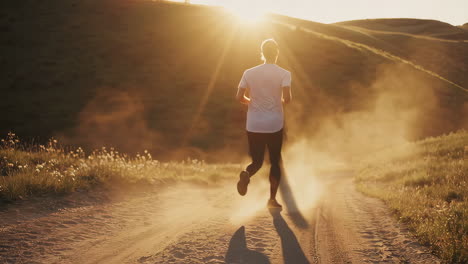 people running on a dusty trail at sunset