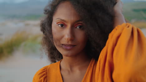 Pretty-african-girl-face-with-bright-makeup-looking-camera-with-smile-close-up.