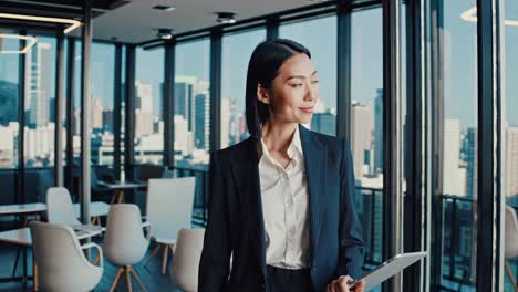 businesswoman in modern office with city view
