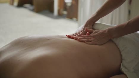 young woman with dowager's hump getting deep tissue back massage