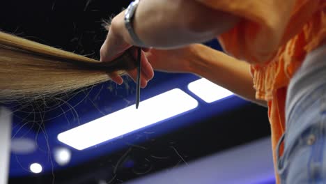 a woman is cutting another woman's hair with scissors as the hair flies around