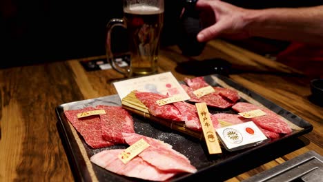 person unpacking various cuts of steak