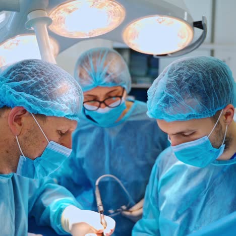 surgical process to a patient by specialists. doctors and assistant use medical instruments during operation in the operating room.