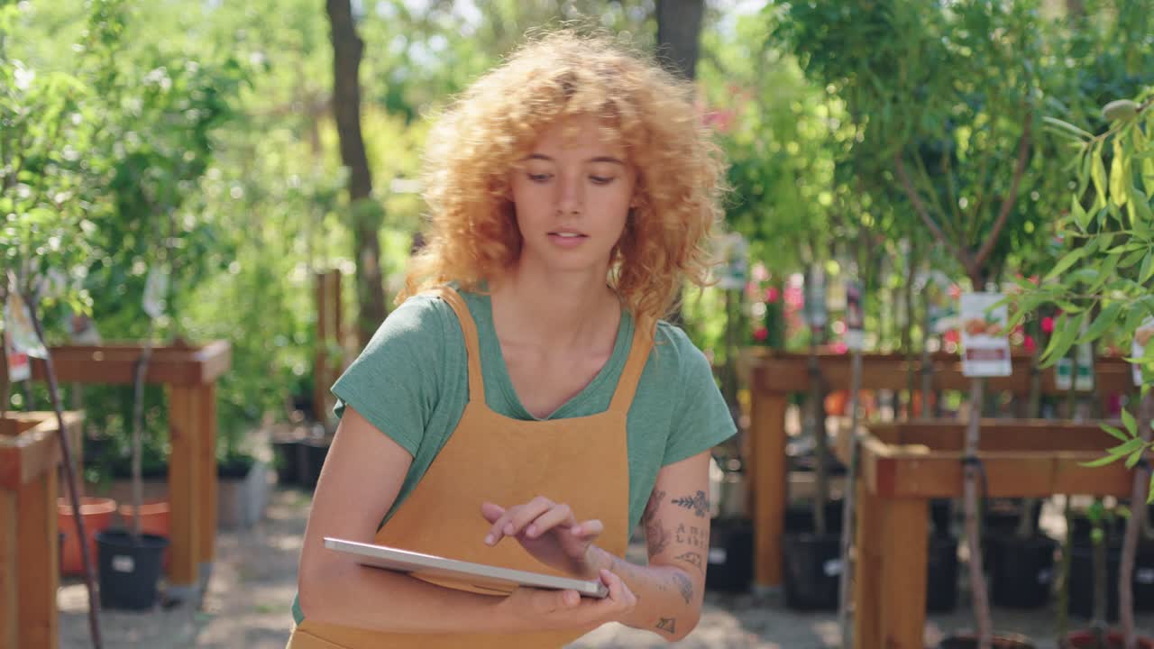 Woman using tablet at garden center