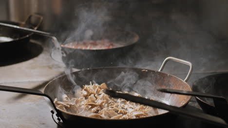 mushrooms being sautéed in a hot pan