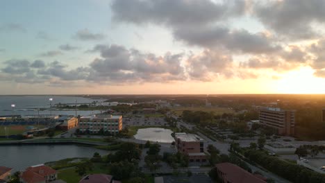 drone shot over historic downtown pensacola in florida near blue wahoos stadium at sunset