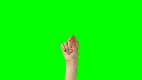 person making hand gesture against green screen background