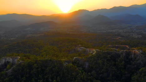 Picturesque-aerial-view-of-the-sun-setting-behind-the-mountains-in-Thailand