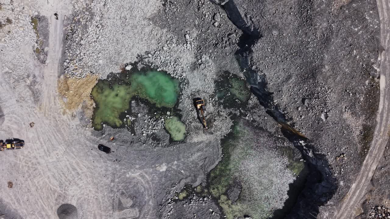 Aerial View of Industrial Quarry with Excavators and Green Water Pools