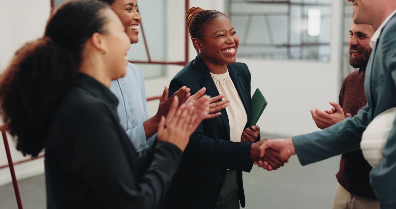 Diverse Business Team Celebrating Success with Handshake and Applause