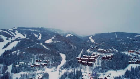 Drone-aerial-shot-of-Telluride-Ski-Village-on-a-cloudy-dark-day