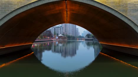 aerial drone flight under bridge in downtown chengdu, china - cinematic