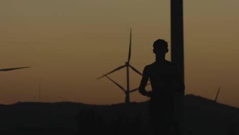 the guy runs towards the camera at sunset. silhouette shooting