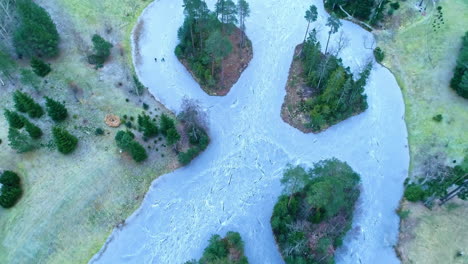 aerial of alberta pond frozen over in latvia