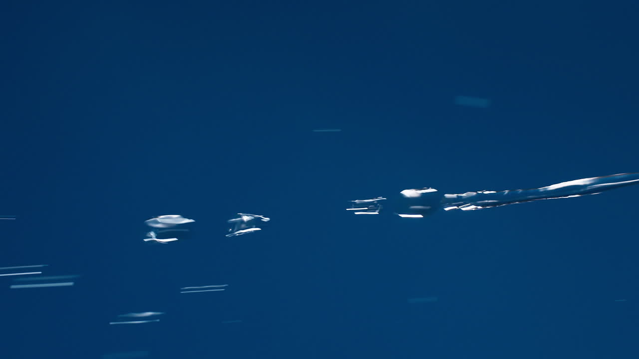 Vertical of Real pure water flowing down with splashing on blue background shooting in slow motion