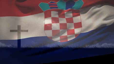 Animation-of-waving-croatia-flag-against-silhouette-of-a-cross-on-grassland-against-clouds-in-sky