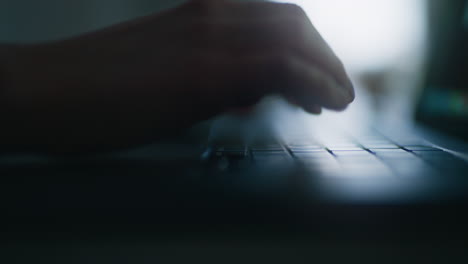 a close-up of hands typing an email on a laptop keyboard