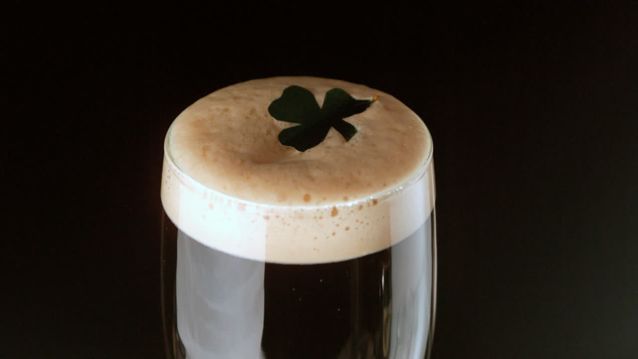 Shamrock landing on head of pint of stout