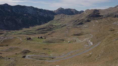 motorcycle drives on a winding road through a mountain pass in montenegro