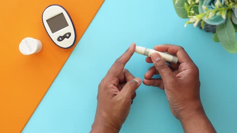 person testing blood sugar level with glucose meter