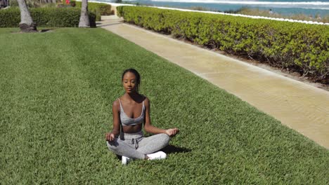 black woman doing yoga on lawn