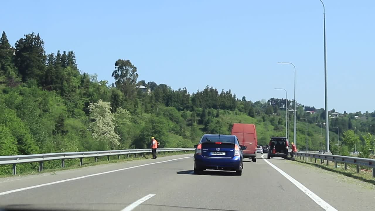 Driving on a highway through a green landscape