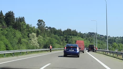 driving on a highway through a green landscape