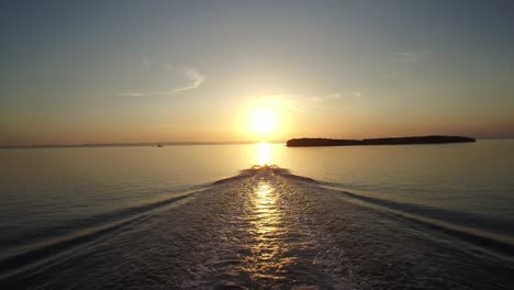 Aerial-shot-of-a-jet-ski-going-toward-the-sun,-Sea-of-Cortez,-Baja-California-Sur