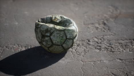 old soccer ball the cement floor