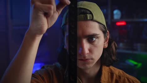 Young Man Examining Film Reel