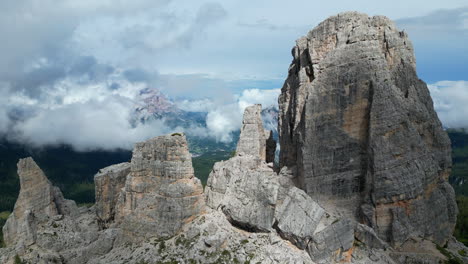 Clouds embracing Cinque Torri in the Dolomites, Italy, creating a breathtaking mountain landscape