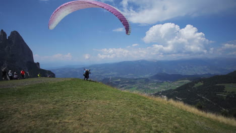 starting paraglider on seisser alm in italy